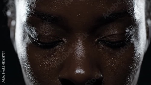 A powerful close-up portrait of a strong and determined Black woman, her face showing focus, intensity, and resilience