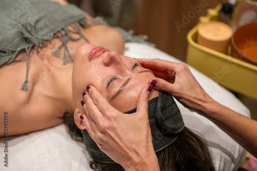 Woman enjoying facial spa treatment and relaxation massage