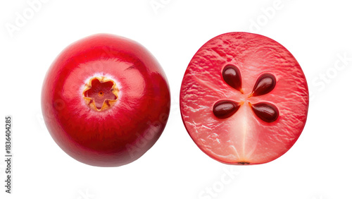 Close-up of whole cranberry next to a cranberry cut in half, showing seeds