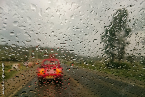 View of a car's windscreen with rain drops and vehicles on a highway in Nairobi Nakuru highway 