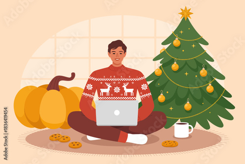 A young man in a festive sweater sits with a laptop, surrounded by pumpkins and a decorated Christmas tree, exuding a cozy and cheerful winter atmosphere.