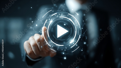 Initiating the Digital Age: A focused individual initiates the digital process of streaming media, pointing at the play button with modern technology, signifying the starting of a new video.