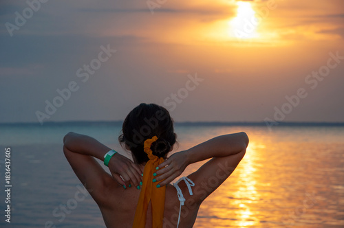 Girl at romantic sunset horizon. Silhouette girl sunrise. Romantic woman sunset sea beach in summer. Woman at sea sunrise. Sunset beach and sky with seascape. Summer sea beach sunrise. Orange skyline
