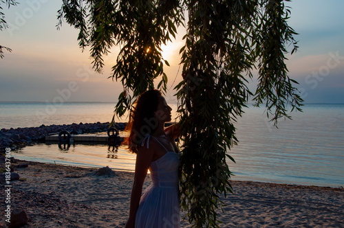 Woman at sea sunrise. Sunset beach sky with seascape. Summer sea beach sunrise. Girl at romantic sunset horizon. Silhouette girl sunrise. Romantic woman at sunset sea beach in summer. Sunset backdrop