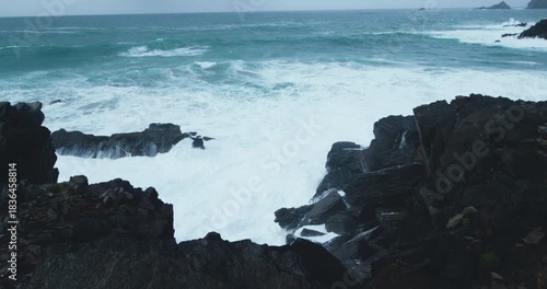 Explore the rugged coastline of Ireland in the Kerry region with crashing waves and rocky shorelines