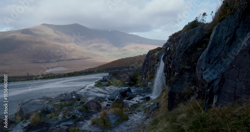 Explore the Kerry region in Ireland with stunning views of mountains and roads along the scenic route on a cloudy day