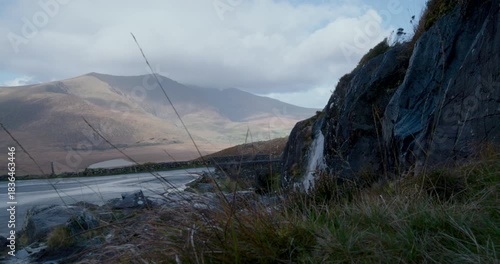 Exploring the Kerry region in Ireland with views of mountains and roads during a cloudy day