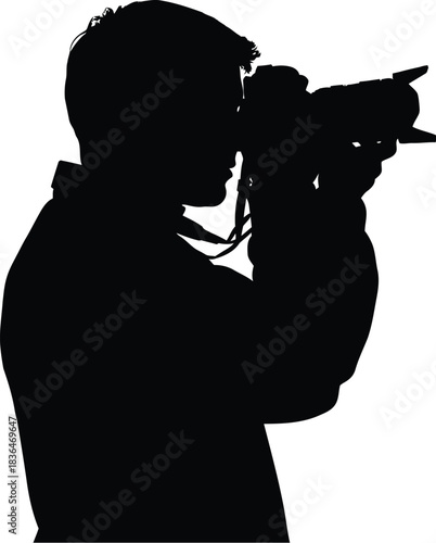 Silhouette of a photographer holding a professional camera taking a picture