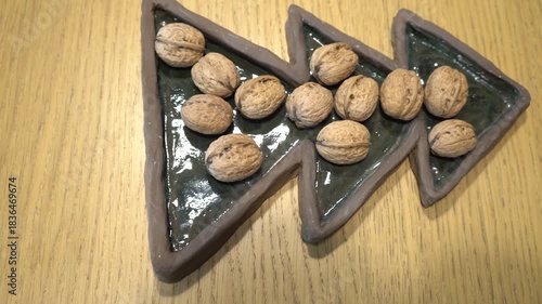 Walnuts arranged on a unique ceramic tray, a still life composition
