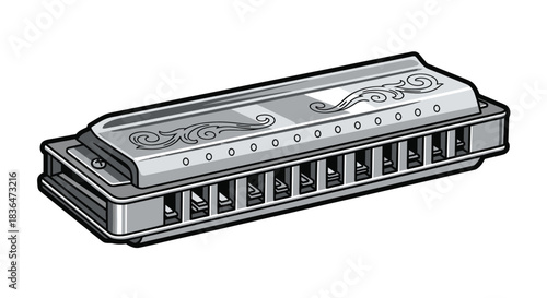 A vintage harmonica with ornate scrollwork on a white background.