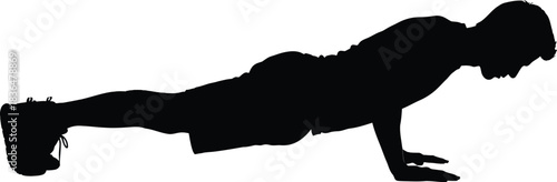 Silhouette of a man performing a push up exercise in a plank position