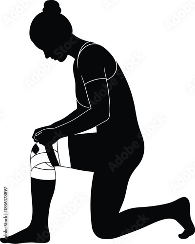 Silhouette of a woman kneeling while putting or adjusting a knee brace or support band for injury prevention or recovery