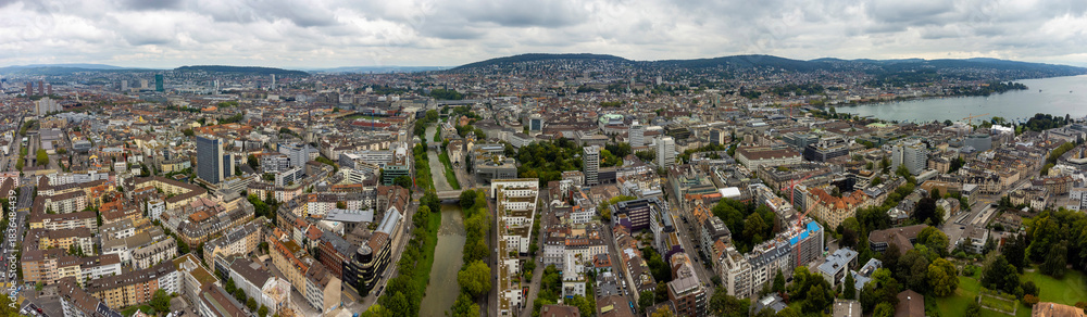 Naklejka premium Aerial panoramic view of the city Zürich in Switzerland on a cloudy morning day in summer