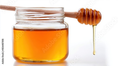 Delicious honey with a wooden drizzler ready for sweetening treats