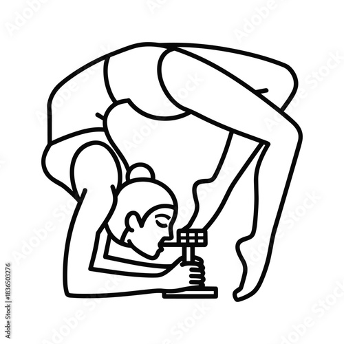 Flexible woman in backbend pose manipulates small tech device.