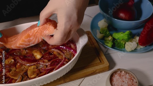 Chef preparing salmon fillets for baking