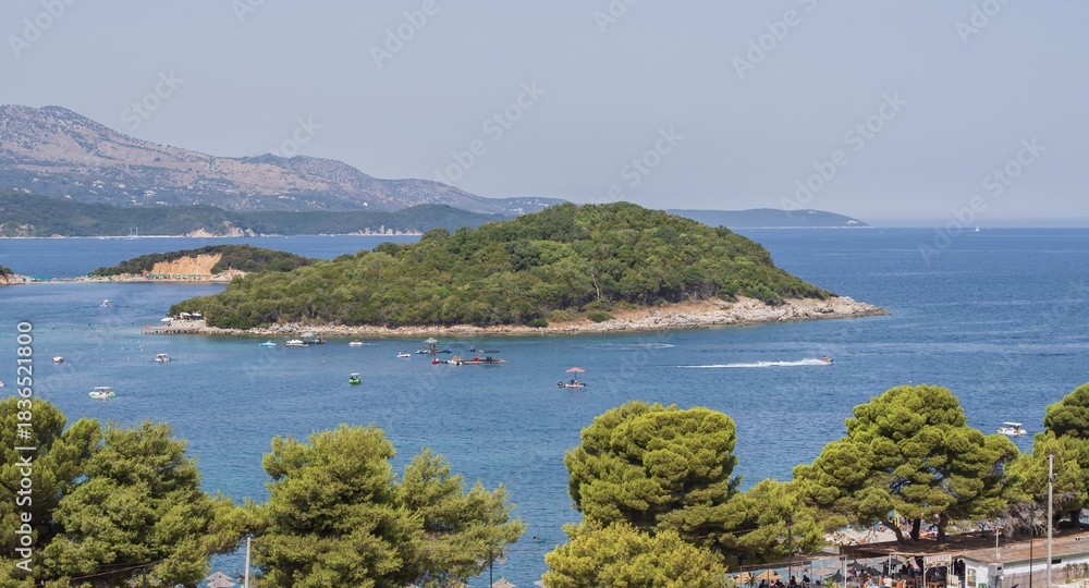 Obraz premium Panoramic Ksamil coastline with turquoise Ionian Sea and islands in Albania on a sunny summer day