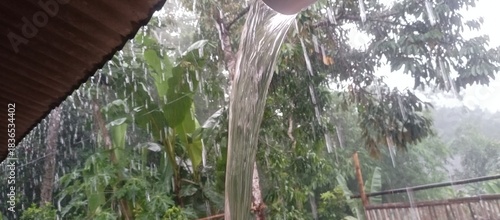 Heavy Rain Pours Down Gutters in Lush Green Neighborhood