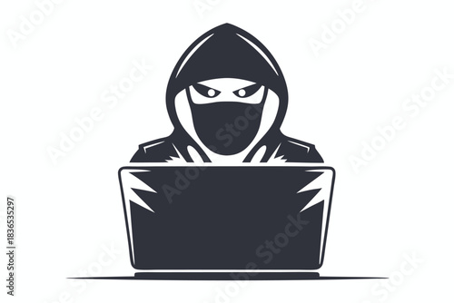 Silhouette of a hooded figure appears to be using a laptop at a desk