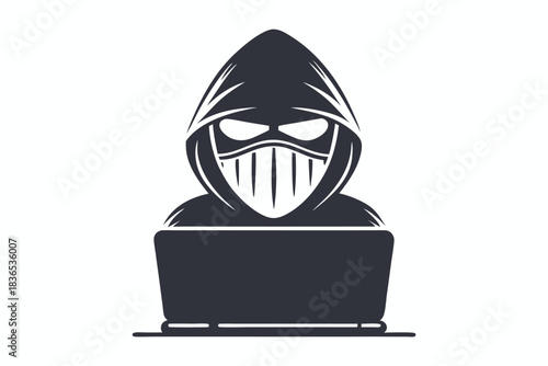 Silhouette shows anonymous figure with mask and hood using a laptop device