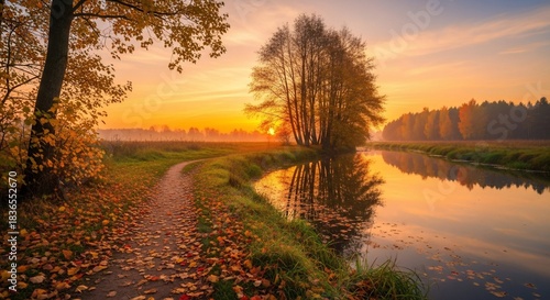 Autumn river landscape at sunrise with trees and golden light