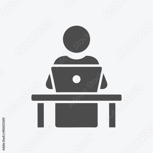 Minimalist icon shows faceless figure working at a laptop on a desk symbol