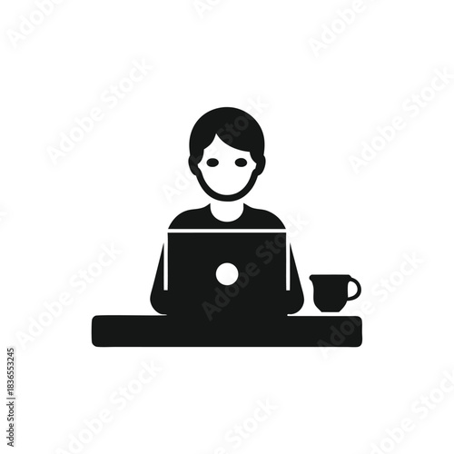 Man works on a laptop at a desk with a clock showing time