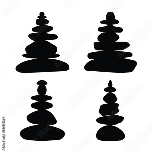Four balanced stone stacks in silhouette representing harmony
