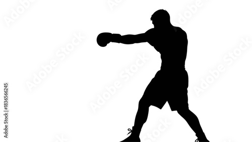 Dynamic silhouette of a boxer throwing a powerful left hook in a dark, high contrast training environment