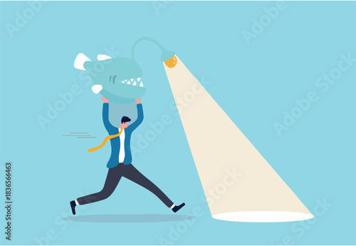 Business direction, flashlight to see opportunity, spotlight to bright success future, leadership and aptitude to solve problem, smart businessman carry angler fish use as flashlight to guide the way.