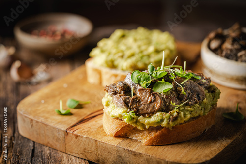 Toast avocado, mushrooms and microgreens whole grain sandwich. Vegetarian food. Vegan menu. Delicious breakfast or snack, Clean eating, dieting, vegan food concept.