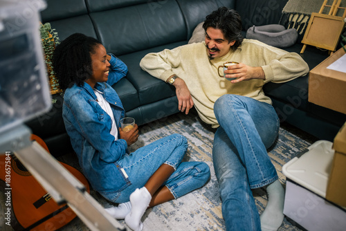 Couple relaxing in new apartment with coffee
