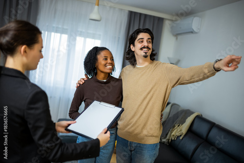 Couple touring apartment with real estate agent