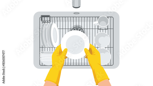 Hands wearing yellow gloves place clean white plate on drying rack above kitchen sink
