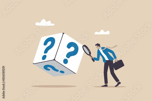Businessman with magnifying glass investigates a large cube with question marks
