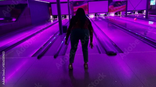 Enthusiast people playing indoor bowling in game zone. Copyspace 4K video of Background gaming zone. Entertainment hobby team game.