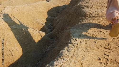 The solitary figure of the Messiah, wearing ancient robes, crossing a barren and rugged landscape. Christian and religious concept of the spiritual journey
