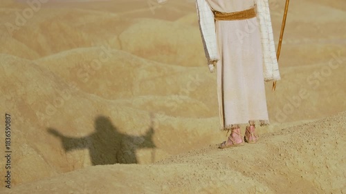 Representation of the Christ crossing a barren and rugged landscape. Christian and religious concept of the spiritual journey