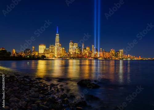 Manhattan view from the Hudson River at sunset with the 911 memorial lights
