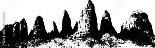 Black and white stencil of desert rock formations with towering spires