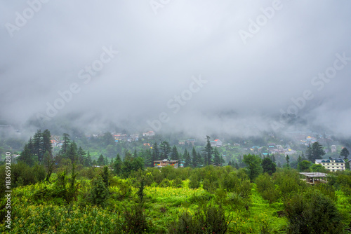 Old Manali town shrouded in misty clouds in Monsoon season. It is a popular Heaven for back packers and nature lovers for its natural beauty of Himalayas in Kullu region.