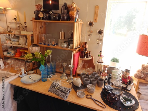 Vintage and everyday household items displayed in a thrift store, second-hand shop interior with retro objects and used goods for resale
