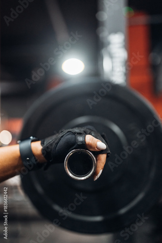 Woman Holding Barbell Close-Up in Gym
