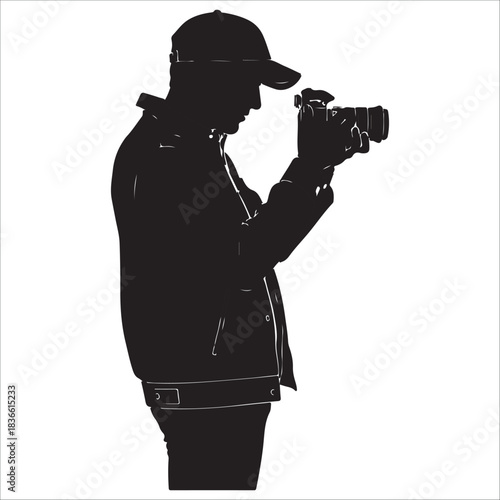 Silhouette of a person wearing a baseball cap filming with a video camera