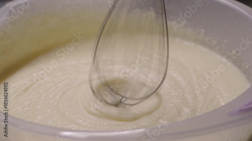 Close-up of kitchen mixer stopping after whipping milk cream for cake