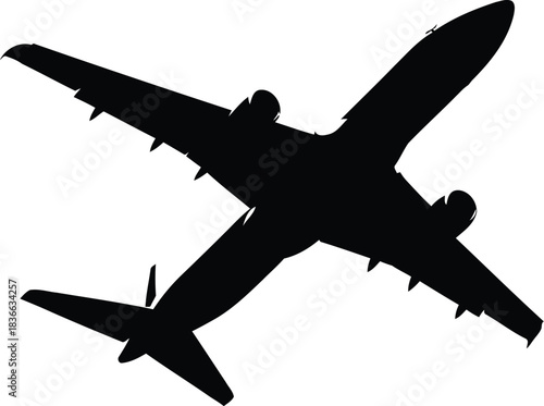 Silhouette of a commercial airplane taking off or climbing against a pure with a faint contrail visible