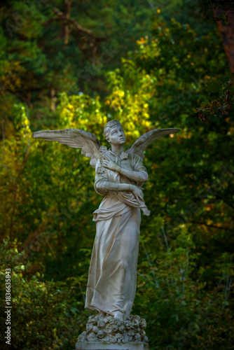 Marble angel statue in autumn park