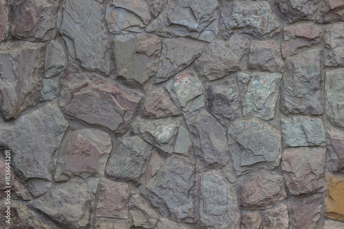 Finishing the building wall with stone.