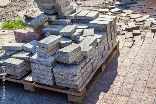 Sidewalk repair. Gray granite tiles on a pallet.