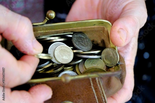 Tableau sur toile An elderly retired woman holds a wallet full of Turkish coins